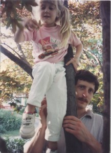 Me learning how to climb the tree in my front yard. My dad\'s standing by for support.